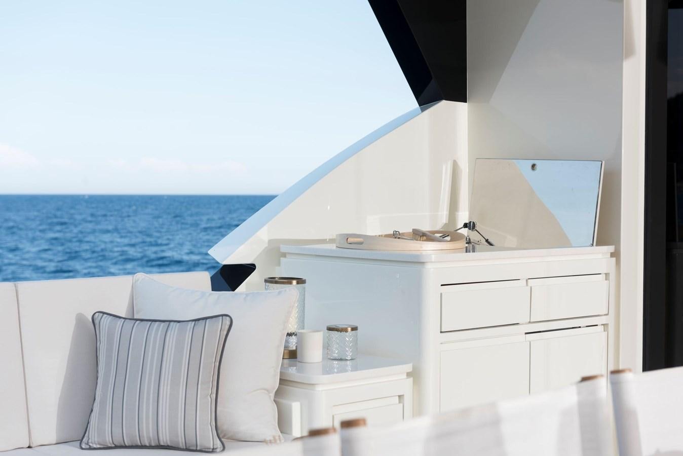 a white bed with a white bed and white drawers aboard SANDRO Yacht for Sale