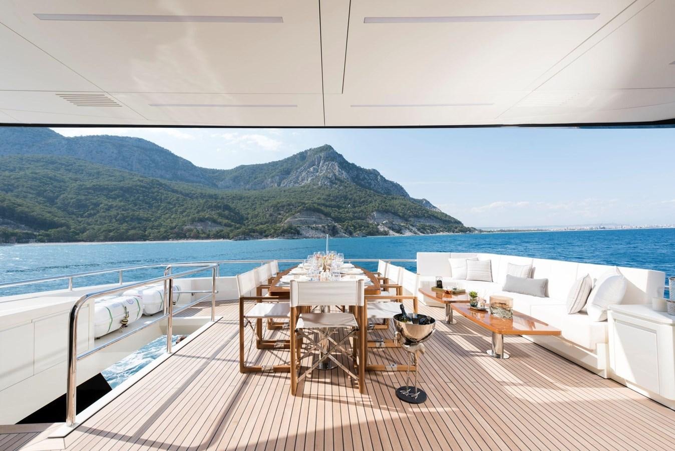 a table on a deck overlooking a body of water aboard SANDRO Yacht for Sale