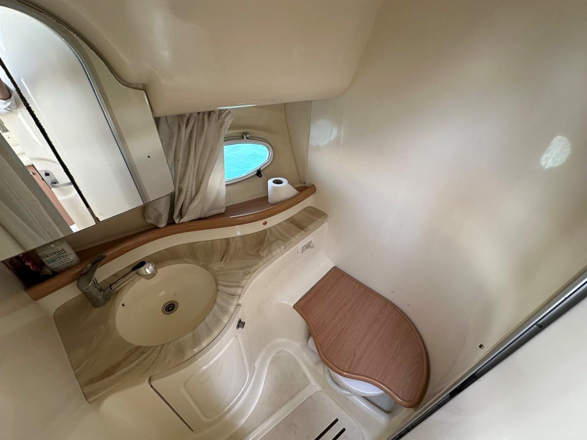 a bathroom with a sink and a mirror aboard 2009 ATLANTIS 315 Yacht for Sale