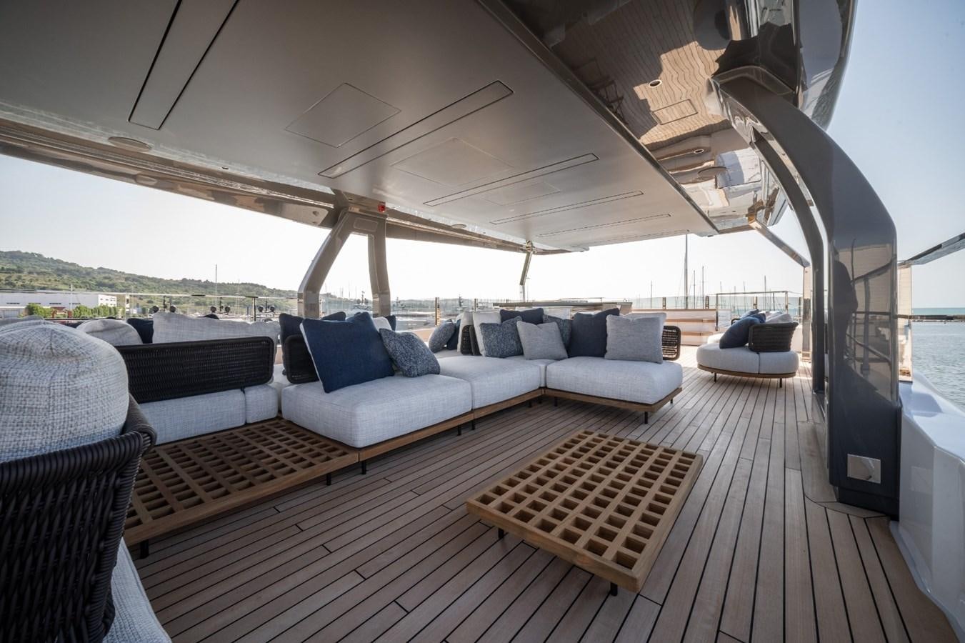 a large living room with a wood floor aboard CUSTOM LINE NAVETTA 42/11 Yacht for Sale