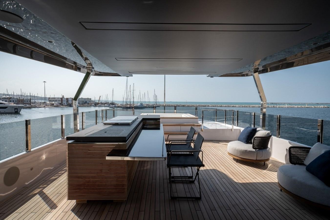 a deck with chairs and a large body of water aboard CUSTOM LINE NAVETTA 42/11 Yacht for Sale