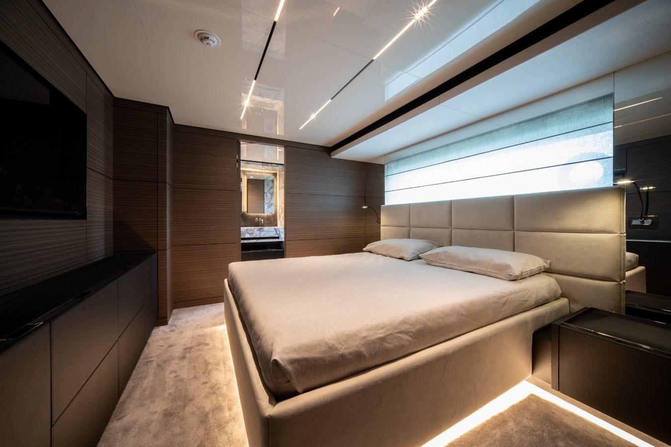 a room with a bed and a window aboard CUSTOM LINE NAVETTA 42/11 Yacht for Sale