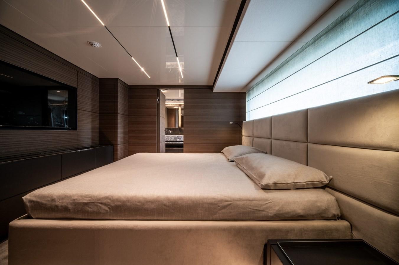 a room with a bed and a window aboard CUSTOM LINE NAVETTA 42/11 Yacht for Sale