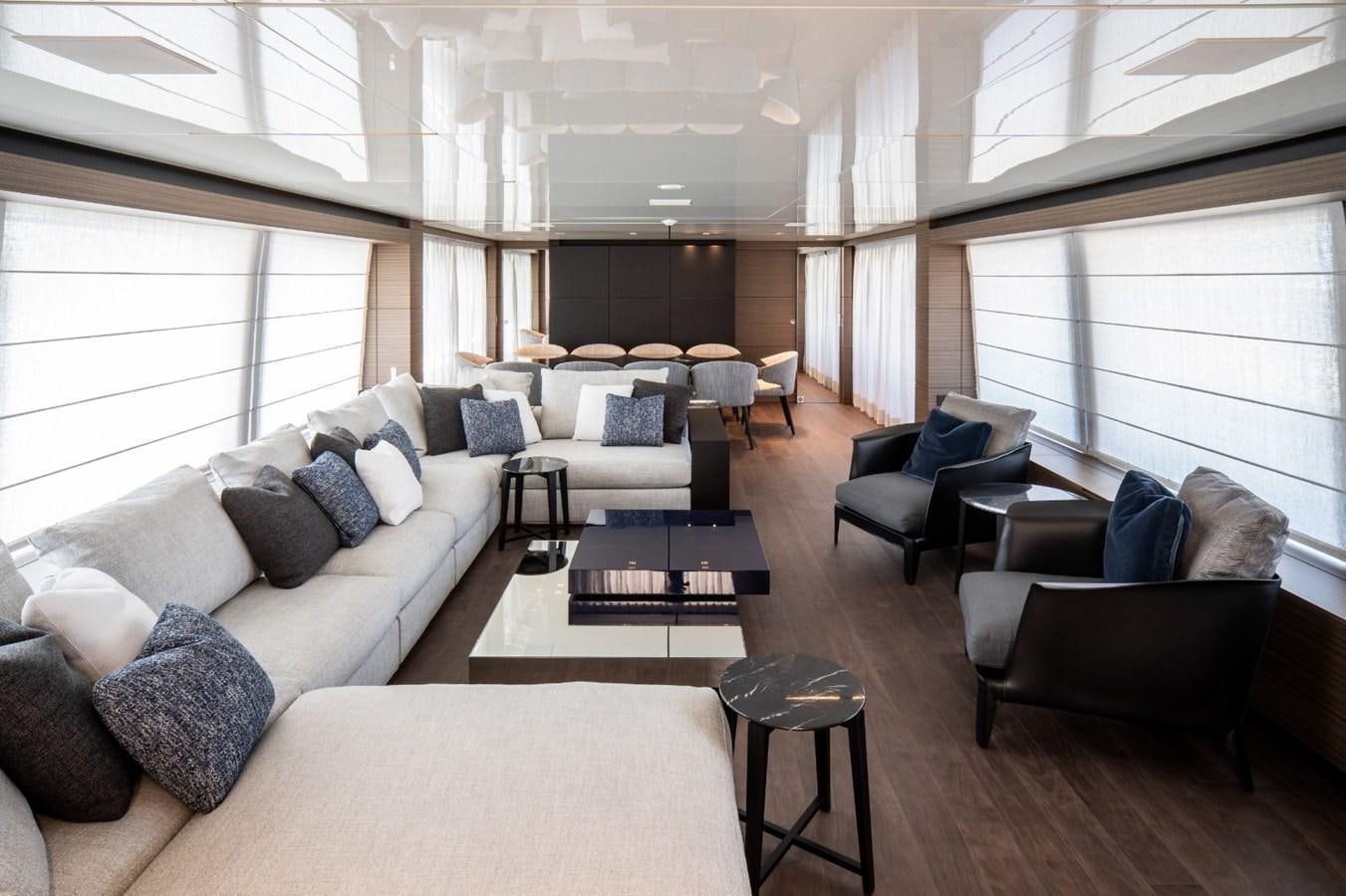 a living room with a couch and a table aboard CUSTOM LINE NAVETTA 42/11 Yacht for Sale