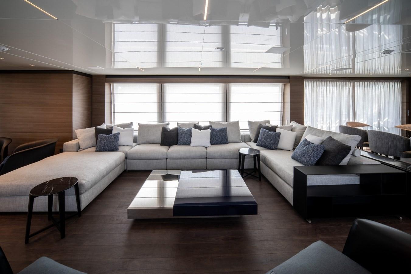 a living room with a couch and a coffee table aboard CUSTOM LINE NAVETTA 42/11 Yacht for Sale