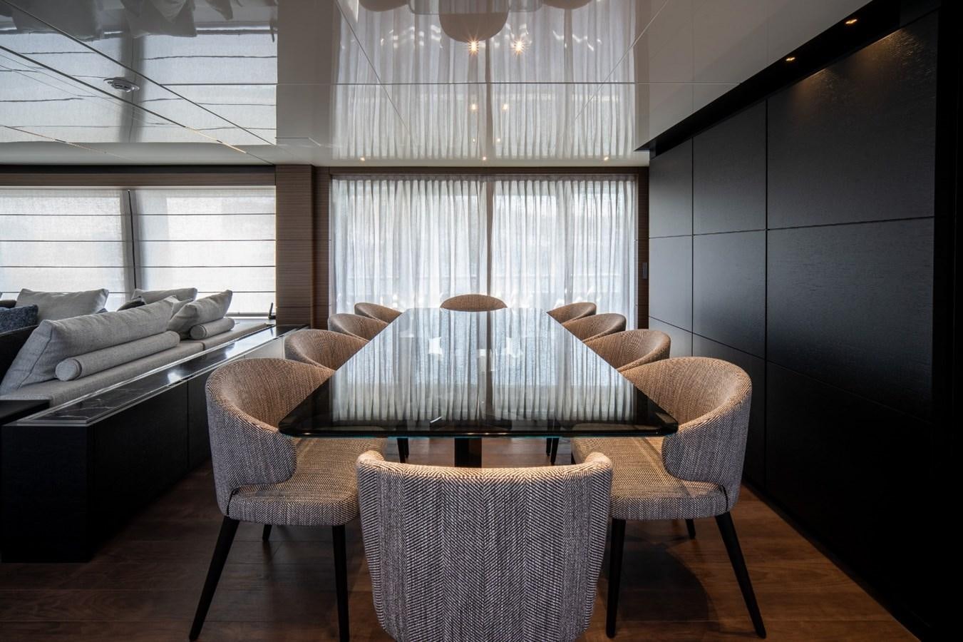 a living room with a table and chairs aboard CUSTOM LINE NAVETTA 42/11 Yacht for Sale