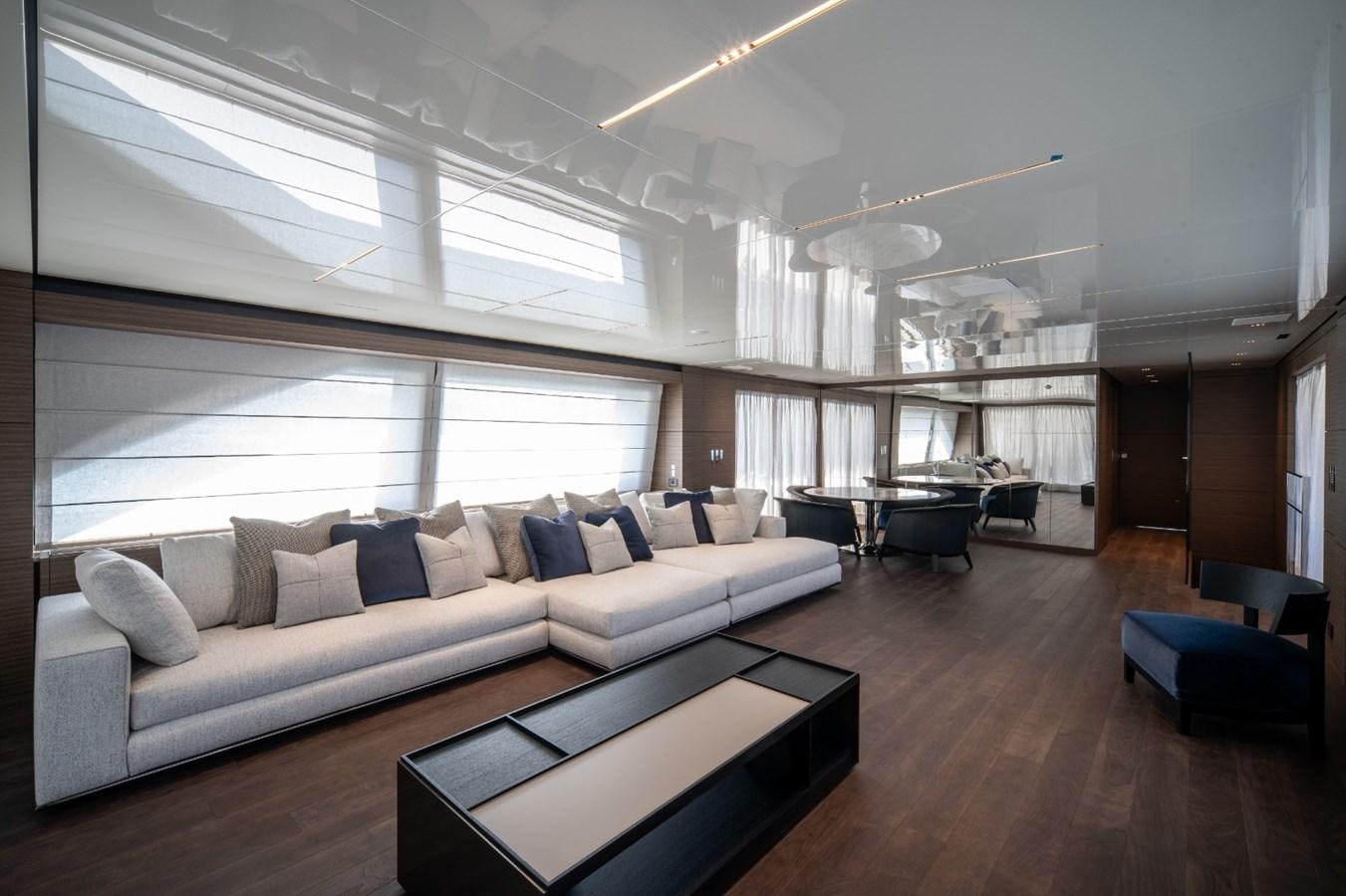 a living room with a couch and a table aboard CUSTOM LINE NAVETTA 42/11 Yacht for Sale