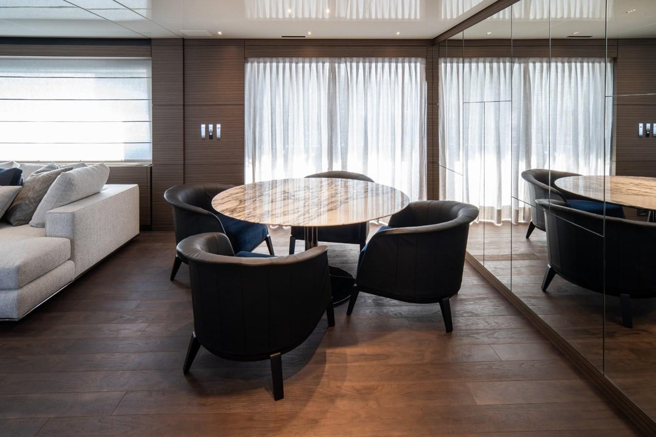 a room with a table and chairs aboard CUSTOM LINE NAVETTA 42/11 Yacht for Sale
