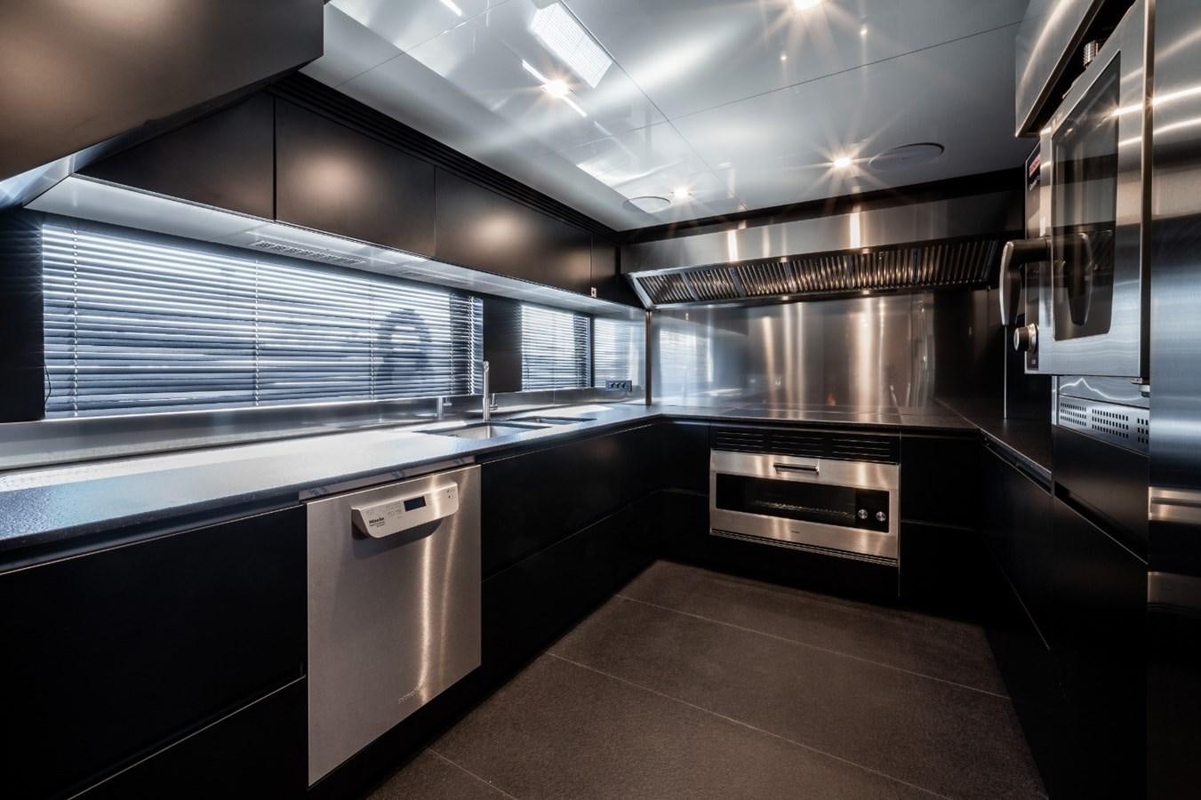 a kitchen with stainless steel appliances aboard CUSTOM LINE NAVETTA 42/11 Yacht for Sale