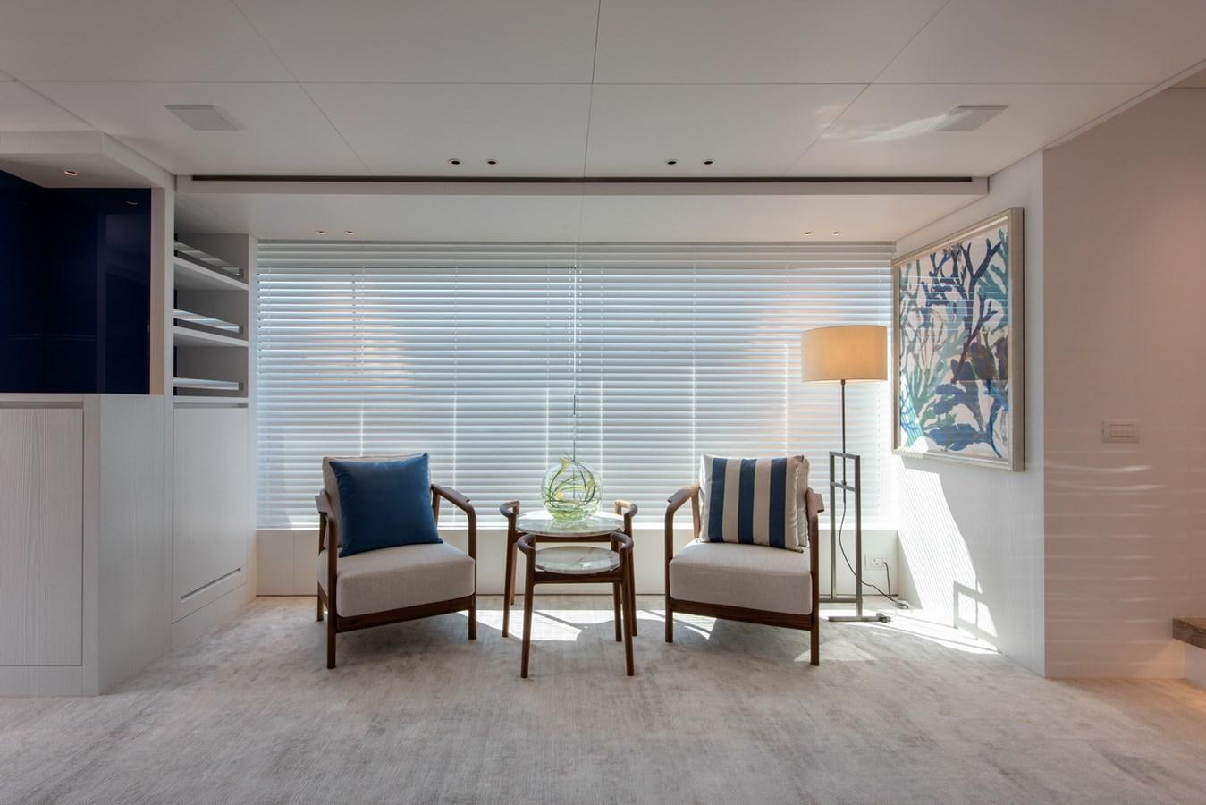 a room with a couch and a table and chairs aboard AGNES Yacht for Sale