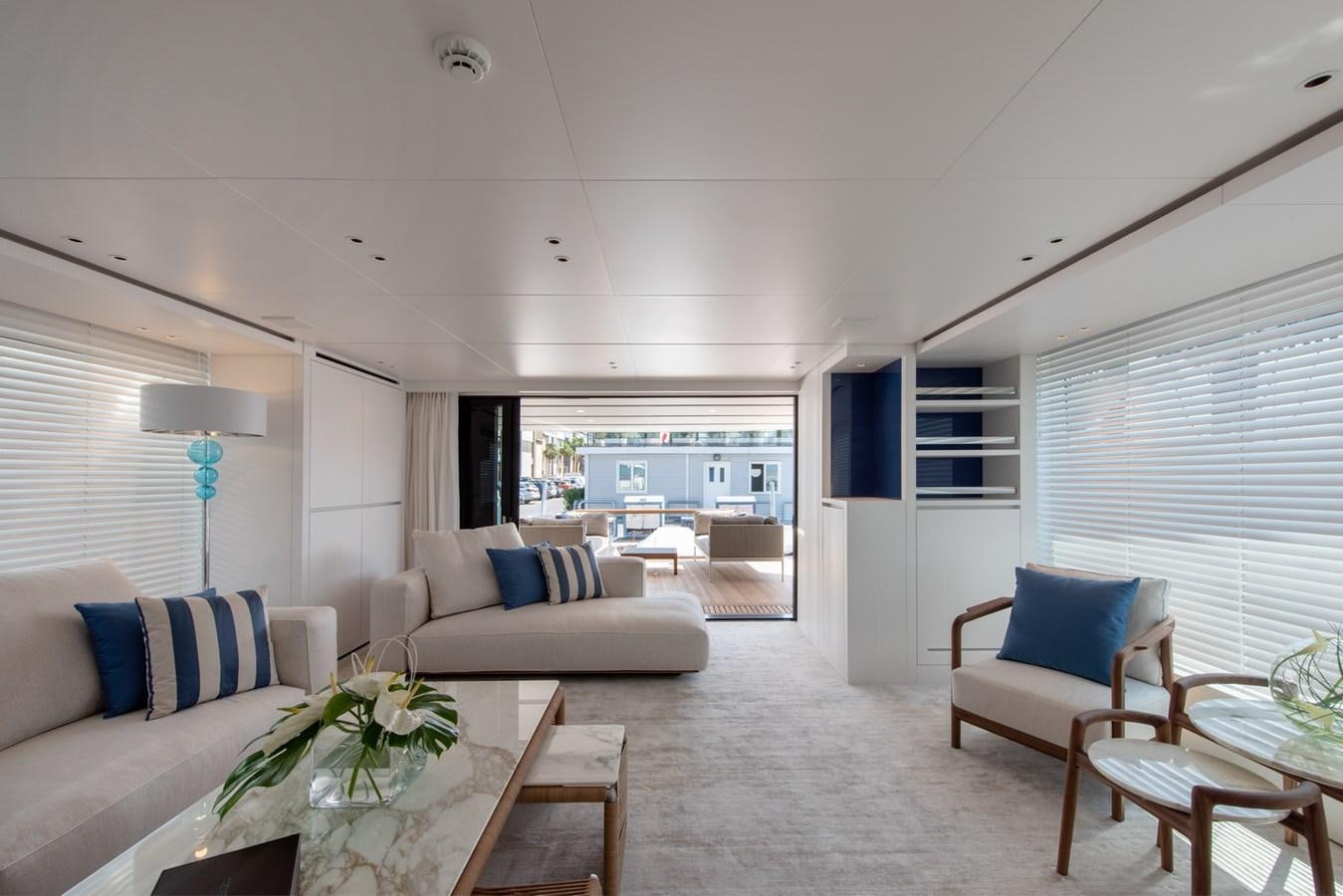 a living room with a couch and a table aboard AGNES Yacht for Sale
