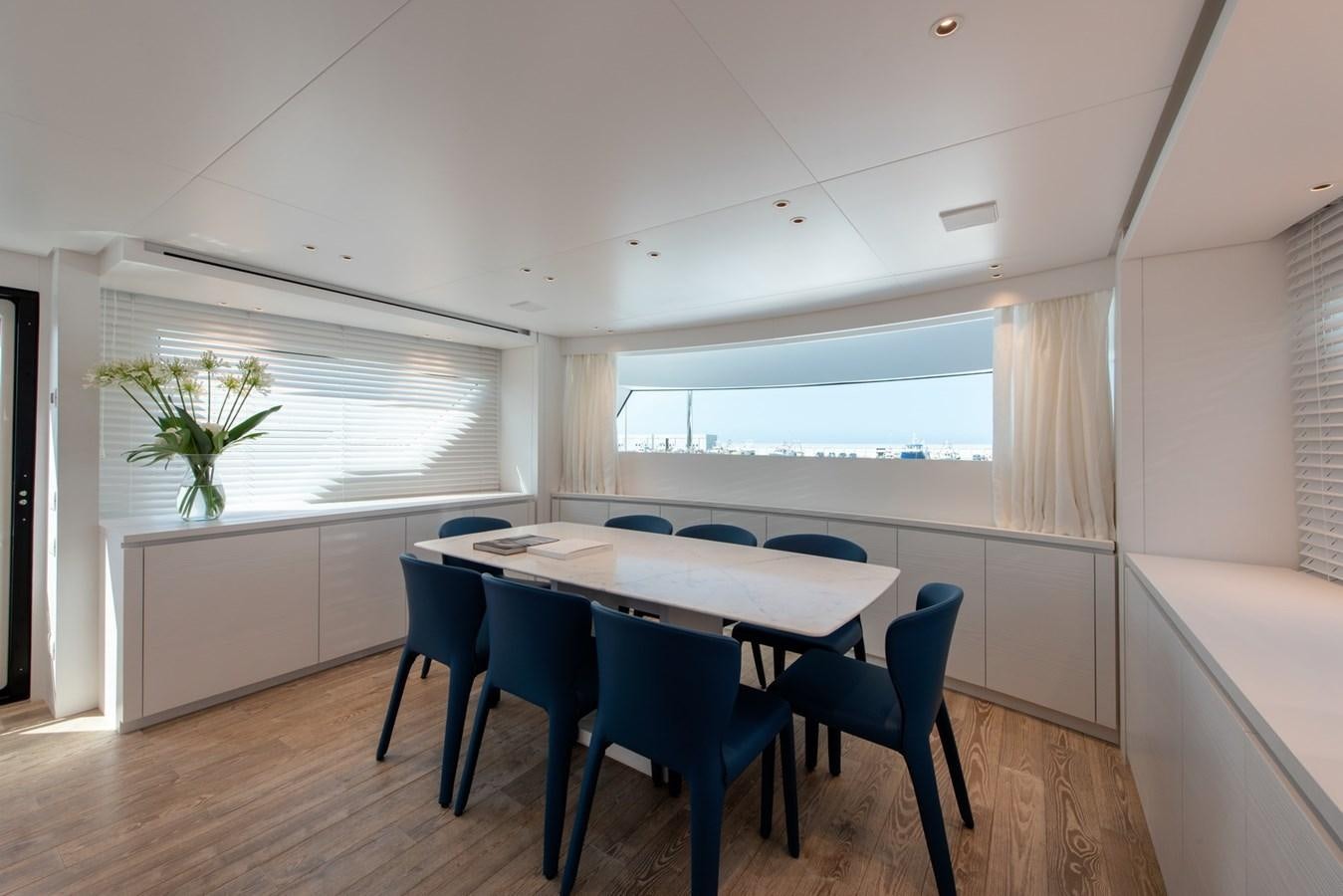 a table and chairs in a room aboard AGNES Yacht for Sale