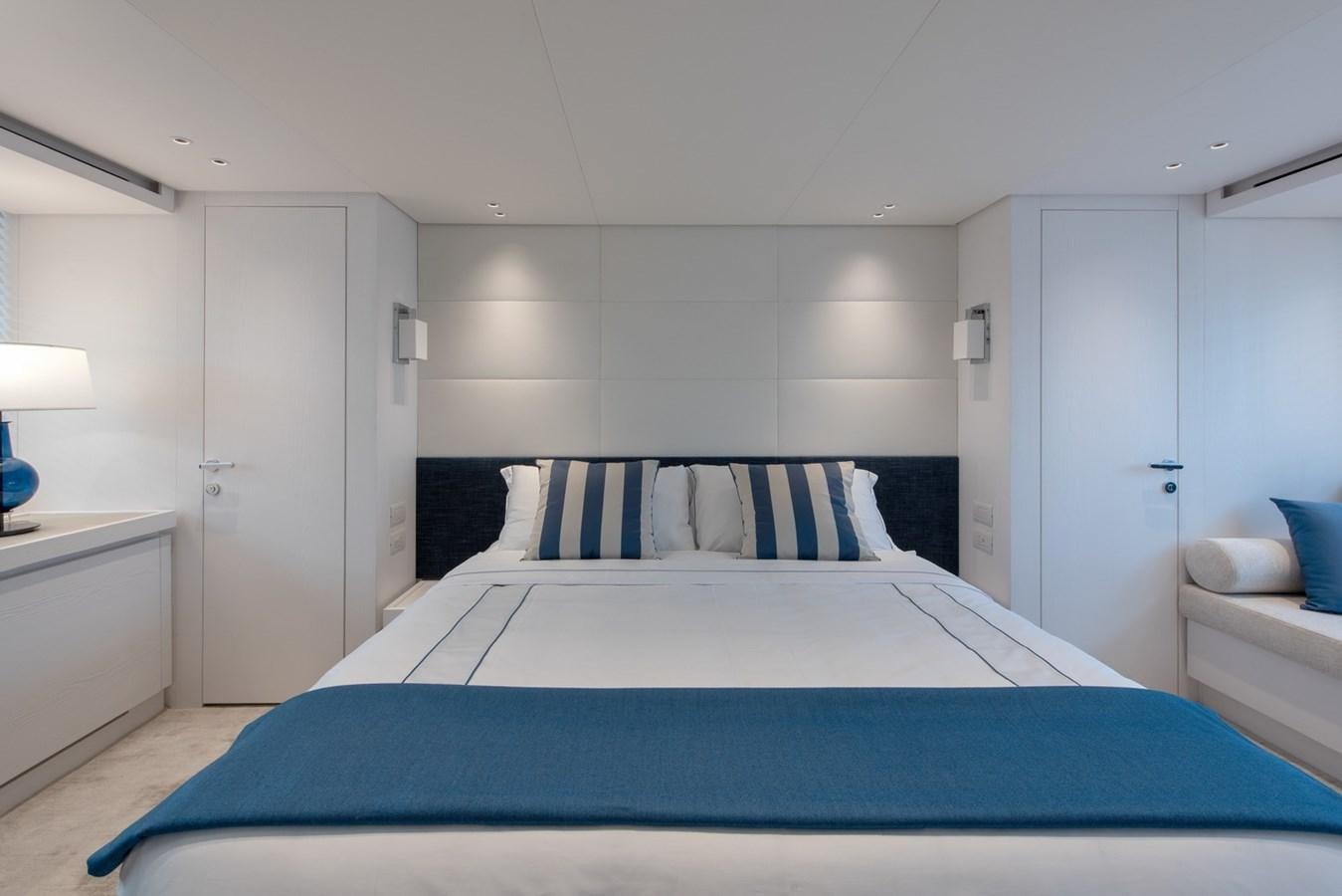 a bedroom with a blue bed aboard AGNES Yacht for Sale