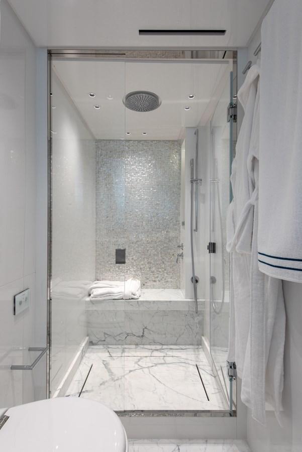 a bathroom with a glass shower aboard AGNES Yacht for Sale