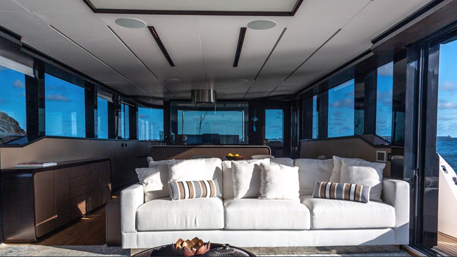 a white couch in a room aboard OKEAN 80/01 Yacht for Sale