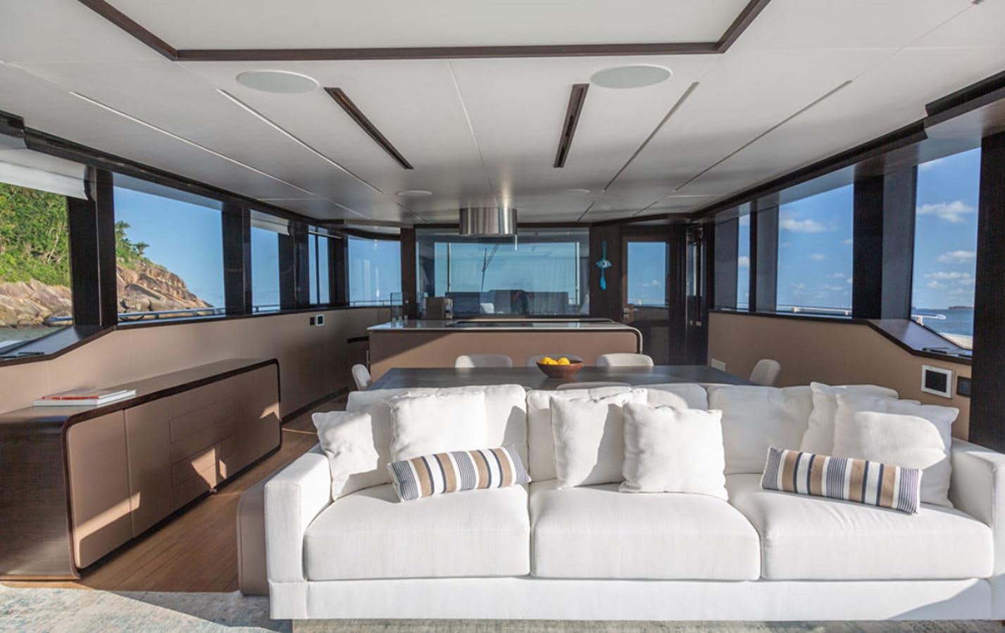 a living room with a large white sofa and a large window aboard OKEAN 80/01 Yacht for Sale