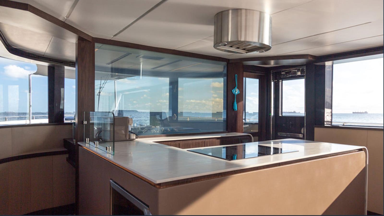a large kitchen with a large island aboard OKEAN 80/01 Yacht for Sale