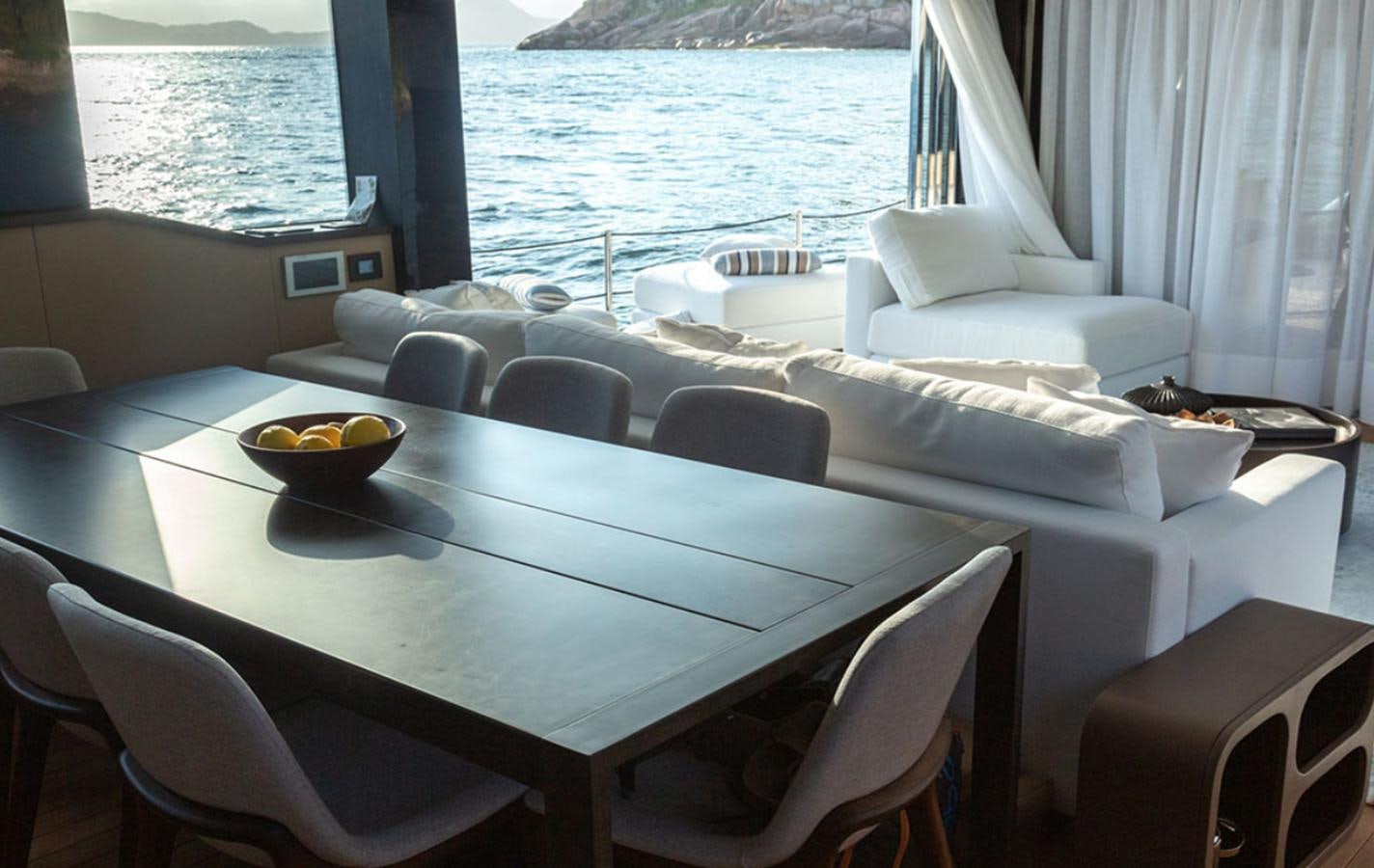 a table with a bowl of fruit on it aboard OKEAN 80/01 Yacht for Sale