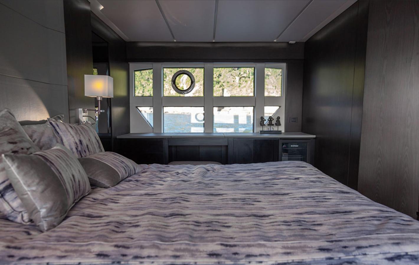 a bed with a large window aboard OKEAN 80/01 Yacht for Sale
