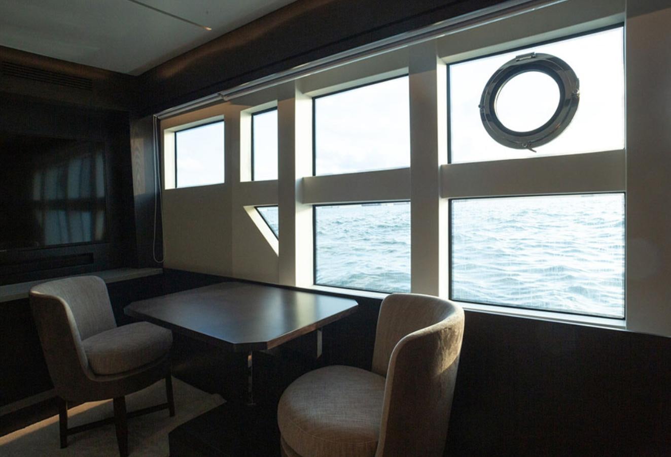 a room with a table and chairs aboard OKEAN 80/01 Yacht for Sale