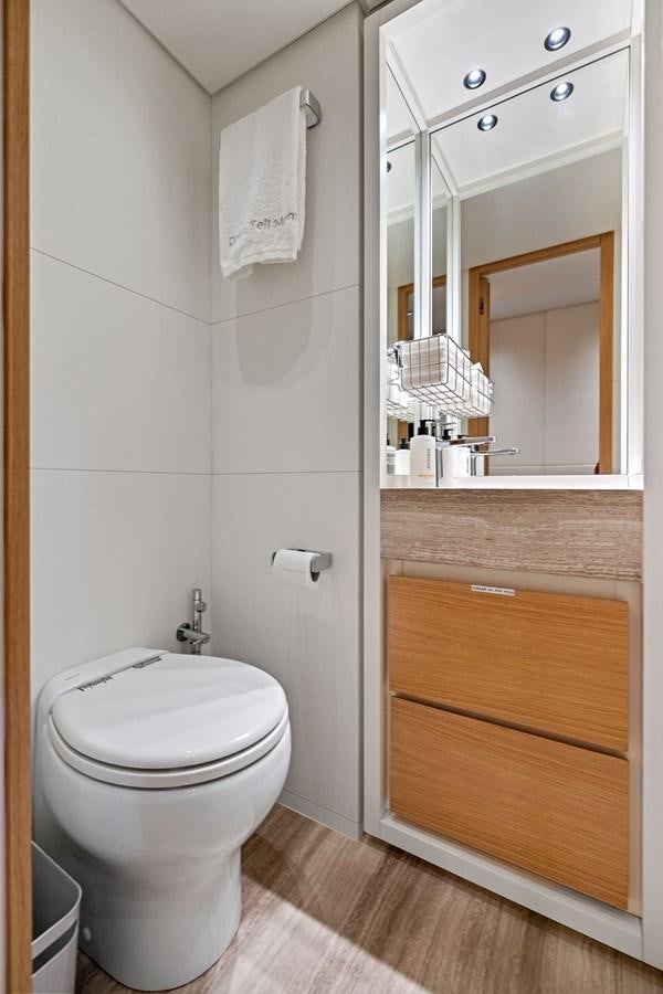 a bathroom with a toilet and a mirror aboard DON'T TELL MOM Yacht for Sale
