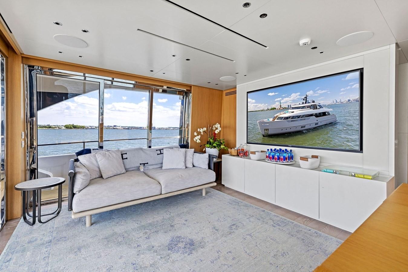 a living room with a large screen aboard DON'T TELL MOM Yacht for Sale