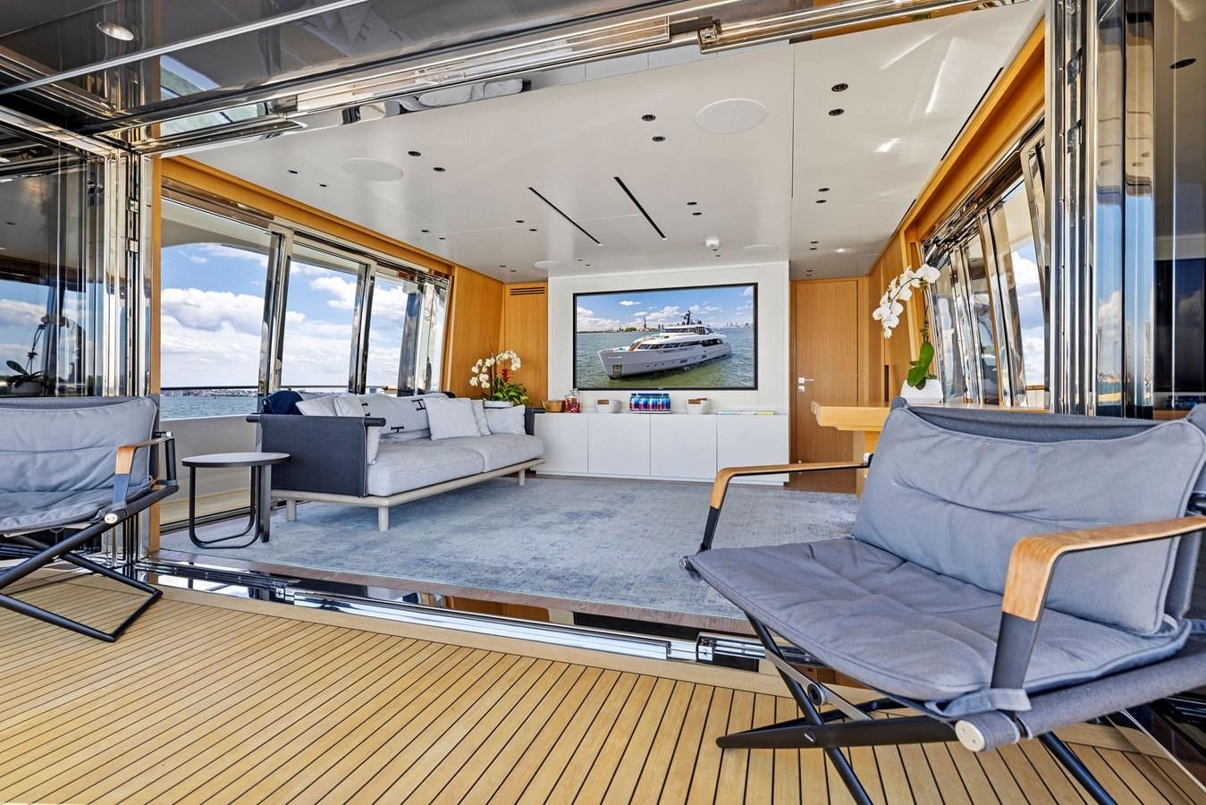 a room with a couch and a television aboard DON'T TELL MOM Yacht for Sale