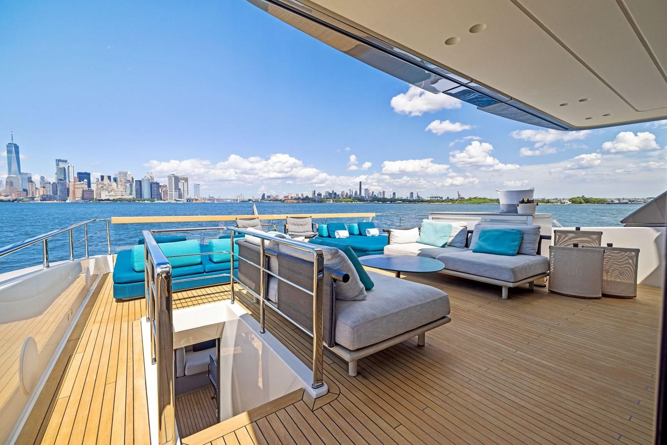 a deck with a view of a city and a body of water aboard DON'T TELL MOM Yacht for Sale