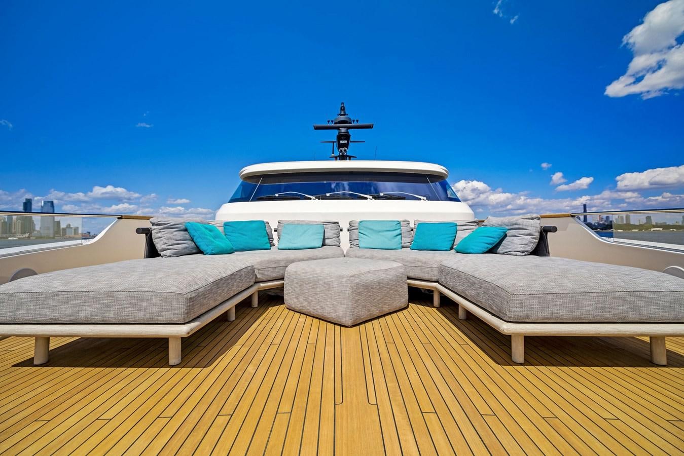a deck with a large boat and a bench on it aboard DON'T TELL MOM Yacht for Sale
