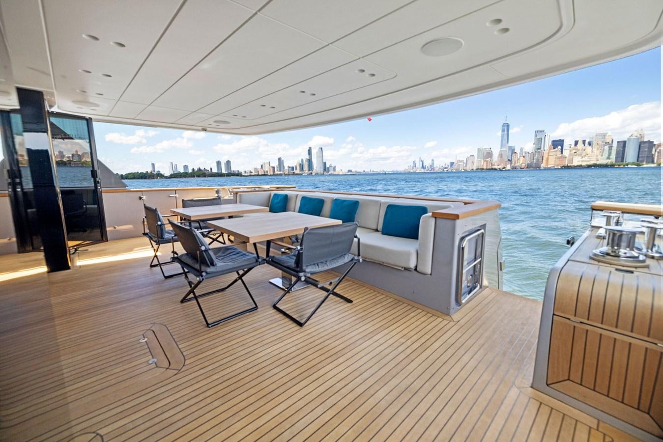 a room with a table chairs and a view of a city aboard DON'T TELL MOM Yacht for Sale