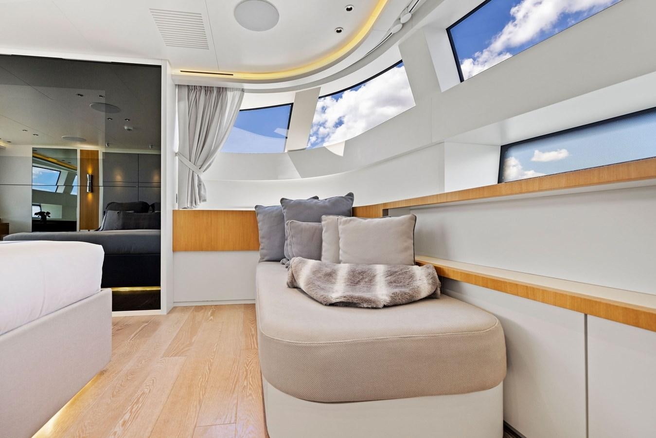 a room with a couch and a mirror aboard DON'T TELL MOM Yacht for Sale
