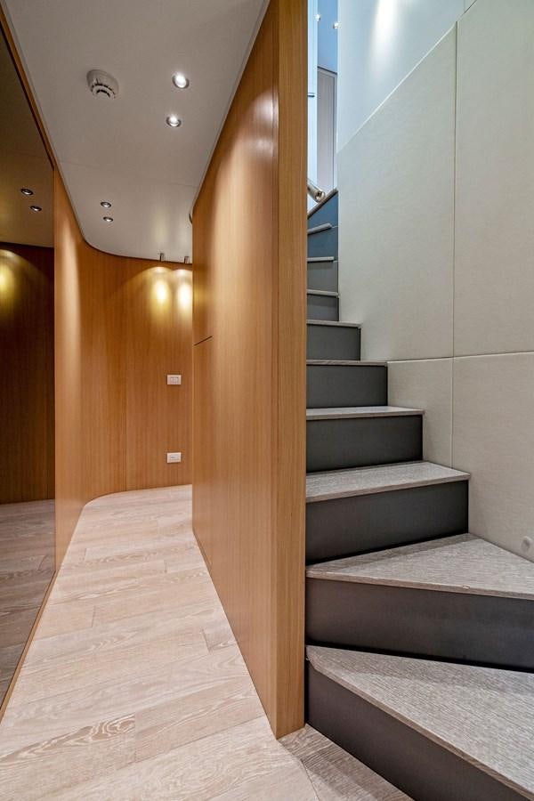 a staircase with a wood railing aboard DON'T TELL MOM Yacht for Sale