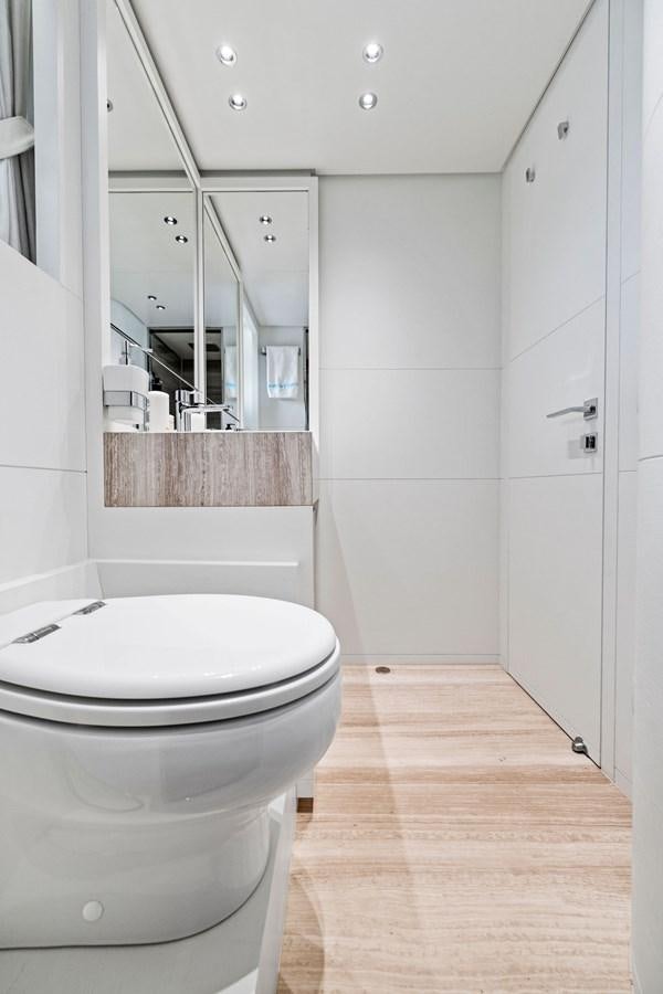 a bathroom with a toilet and a mirror aboard DON'T TELL MOM Yacht for Sale