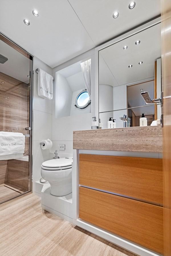 a bathroom with a toilet and a mirror aboard DON'T TELL MOM Yacht for Sale