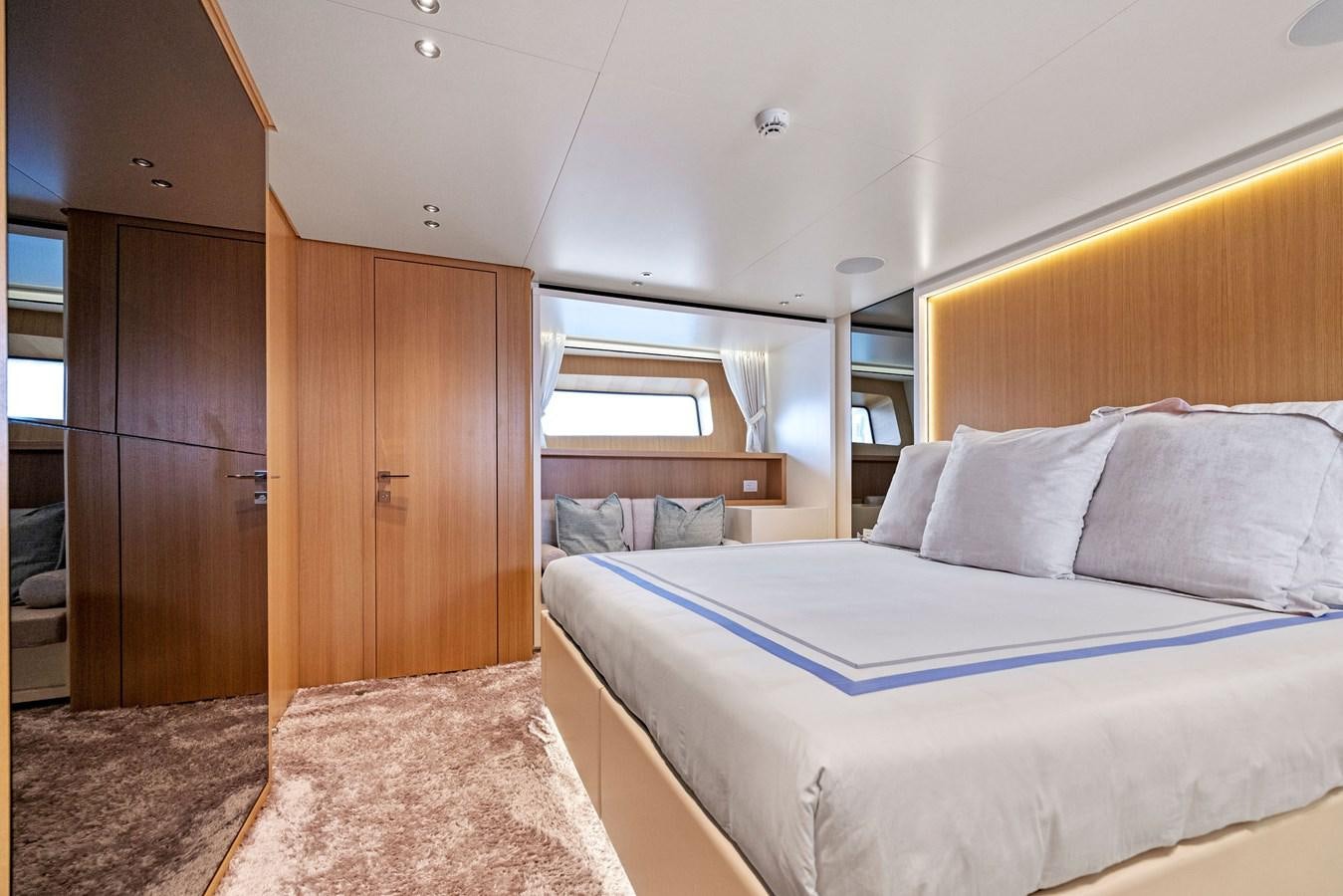 a bedroom with a bed and a wood door aboard DON'T TELL MOM Yacht for Sale