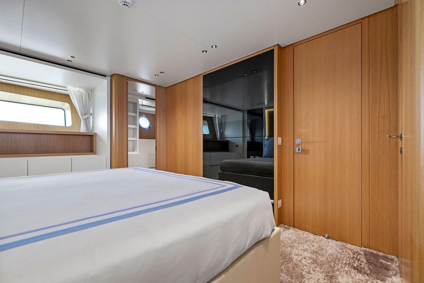 a bedroom with a bed and a closet aboard DON'T TELL MOM Yacht for Sale