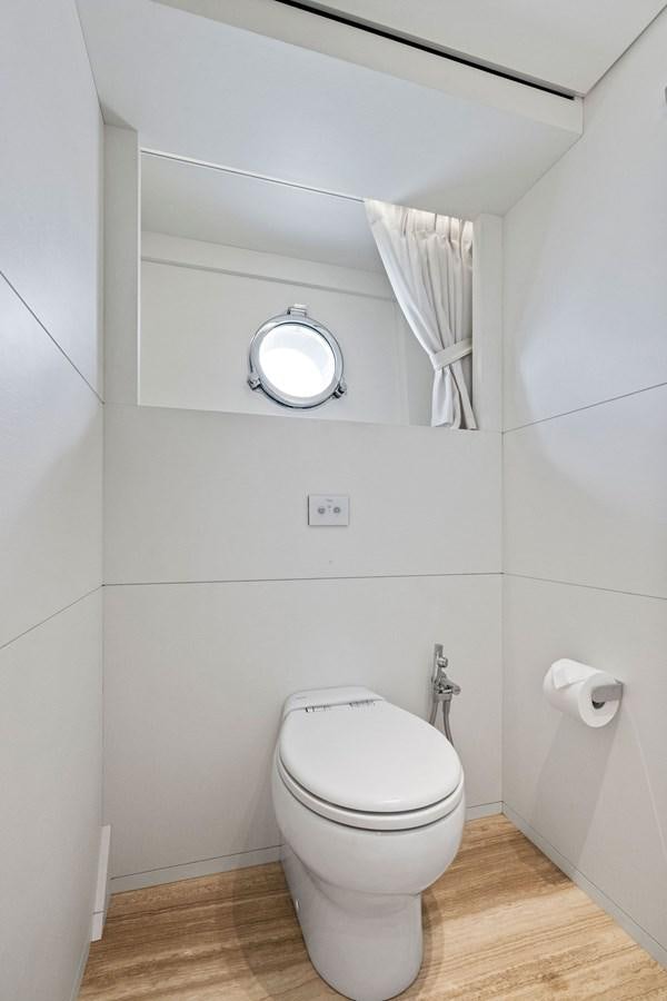 a bathroom with a toilet and a mirror aboard DON'T TELL MOM Yacht for Sale