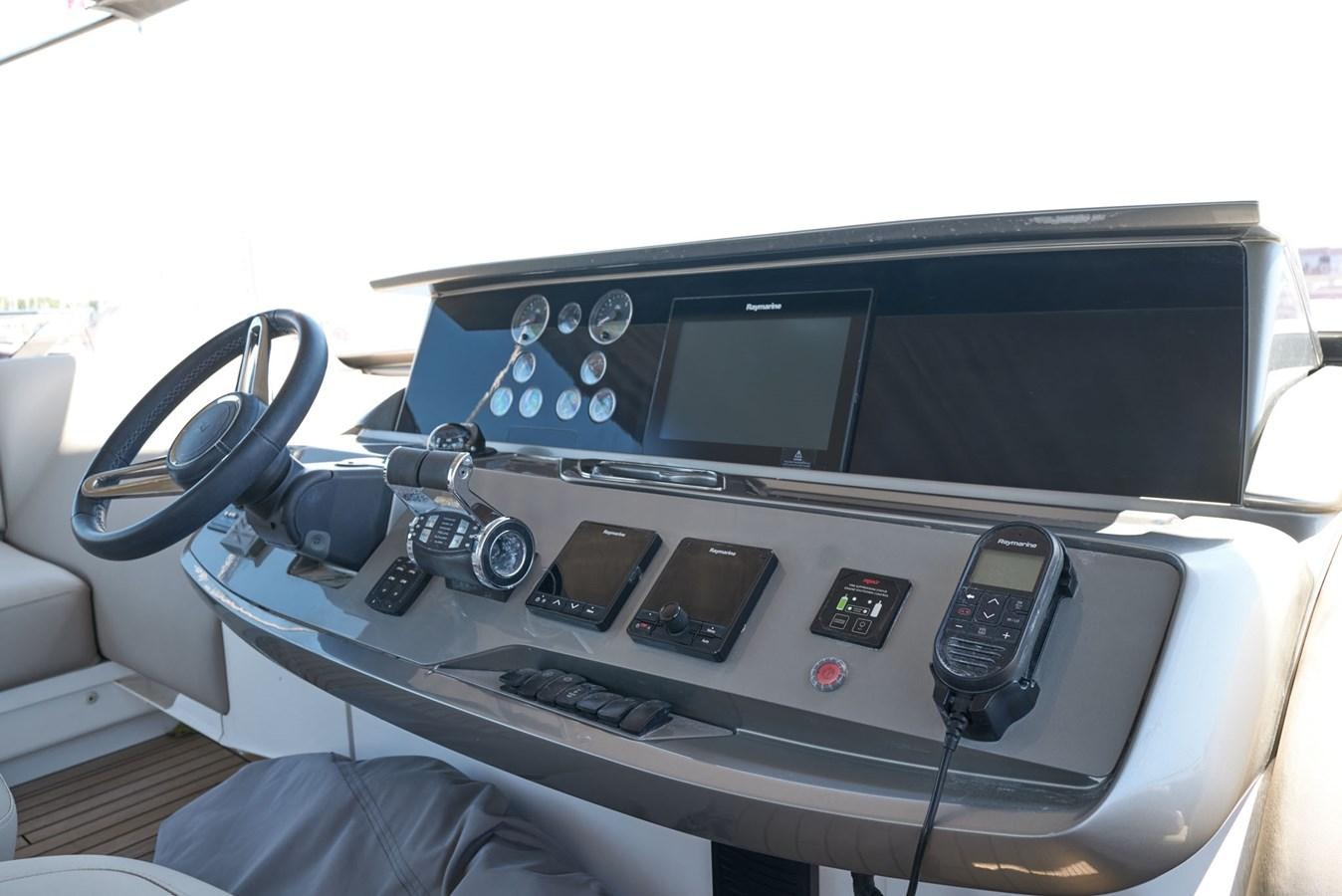 a white car with a screen and a black console and buttons aboard PRINCESS M Yacht for Sale