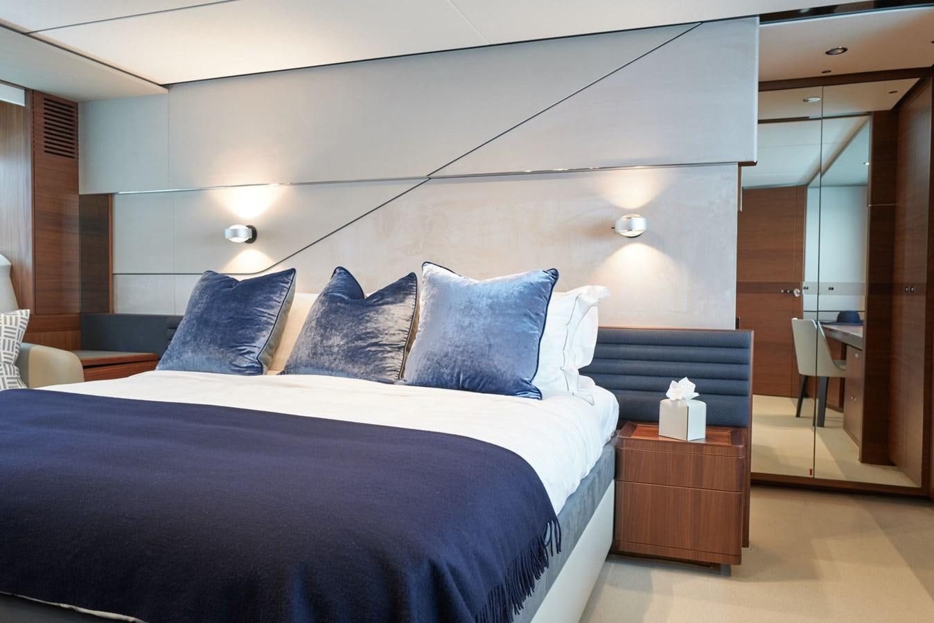 a bed with blue sheets aboard PRINCESS M Yacht for Sale