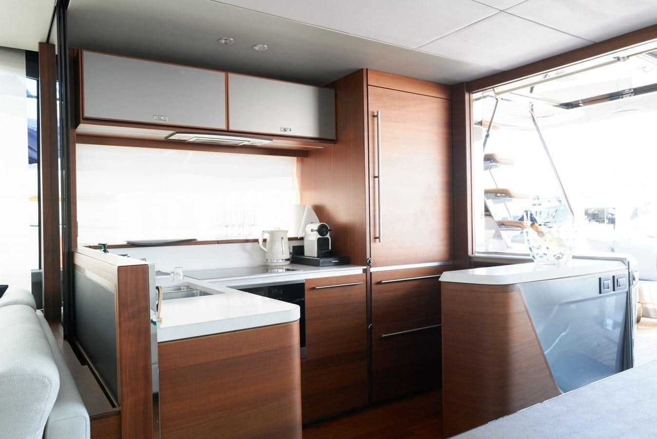 a kitchen with white cabinets aboard PRINCESS M Yacht for Sale
