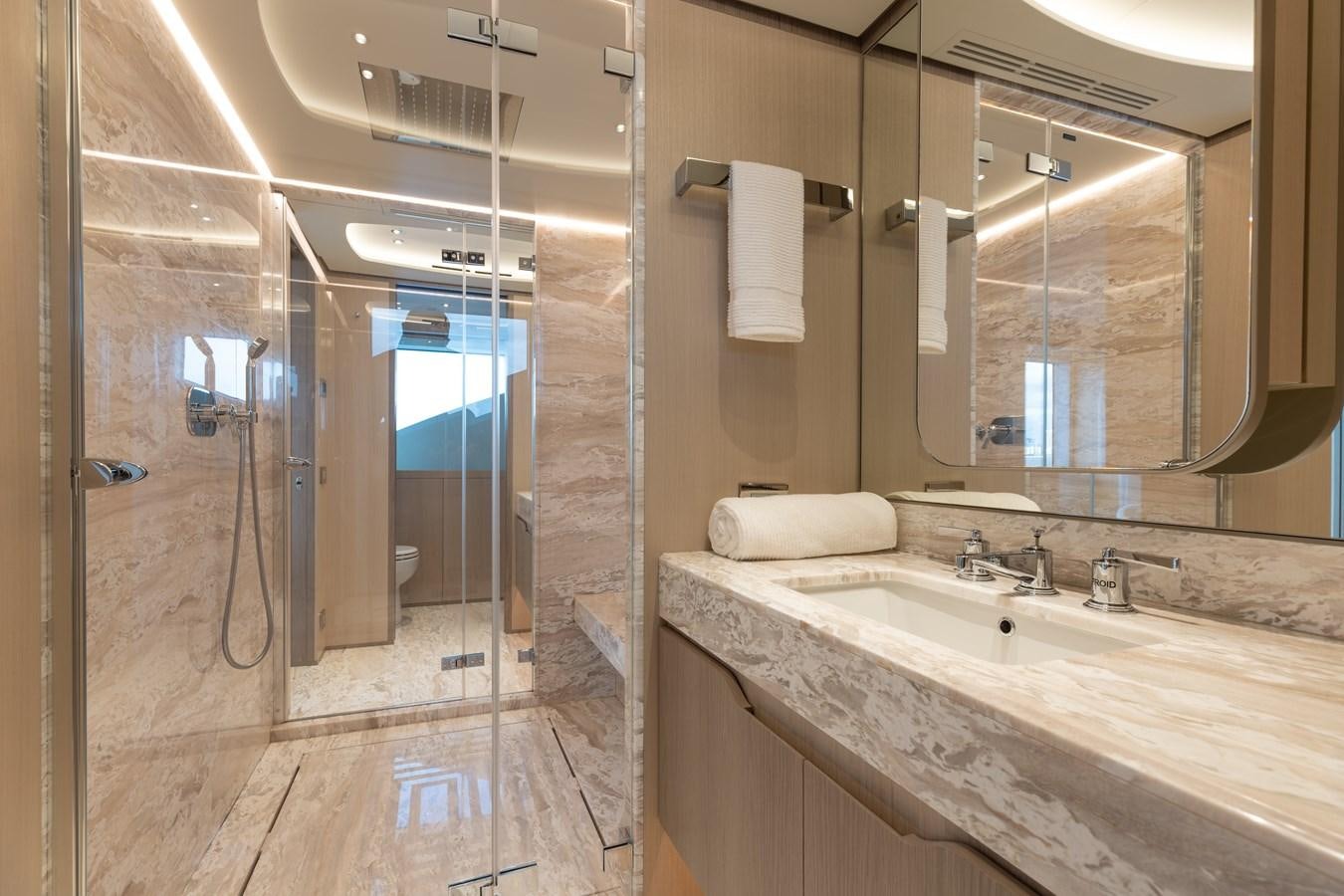 a bathroom with a large mirror aboard ABBENTURES III Yacht for Sale