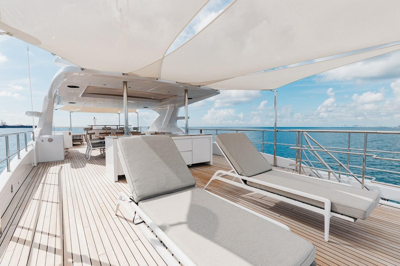 a deck with a large deck and a large boat on it aboard ABBENTURES III Yacht for Sale