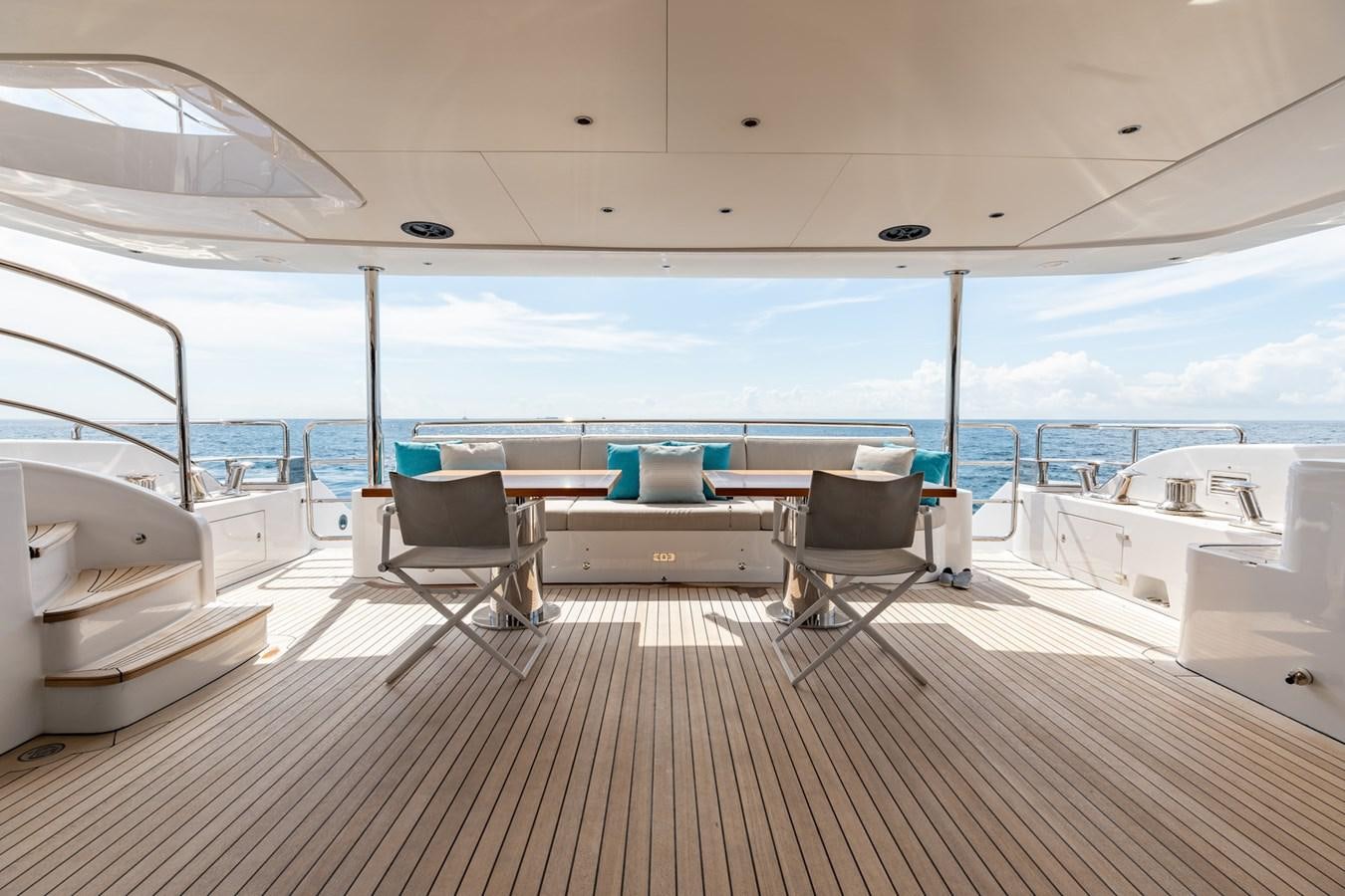 a room with a table and chairs on a deck aboard ABBENTURES III Yacht for Sale