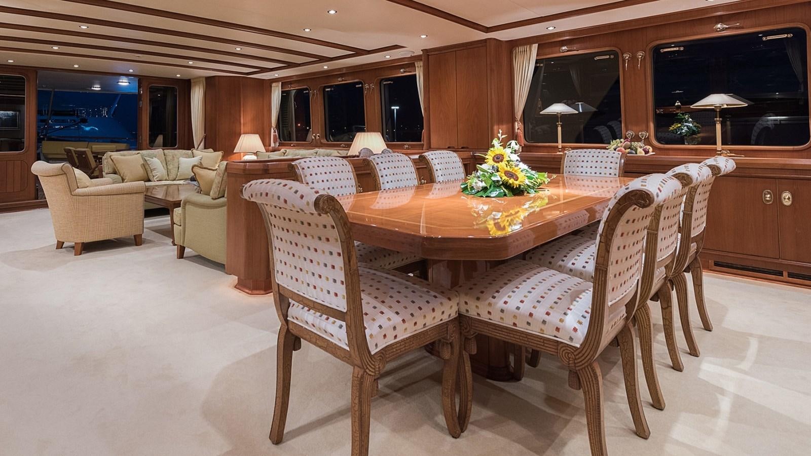 a dining table in a living room aboard LA REINA DEL MAR Yacht for Sale