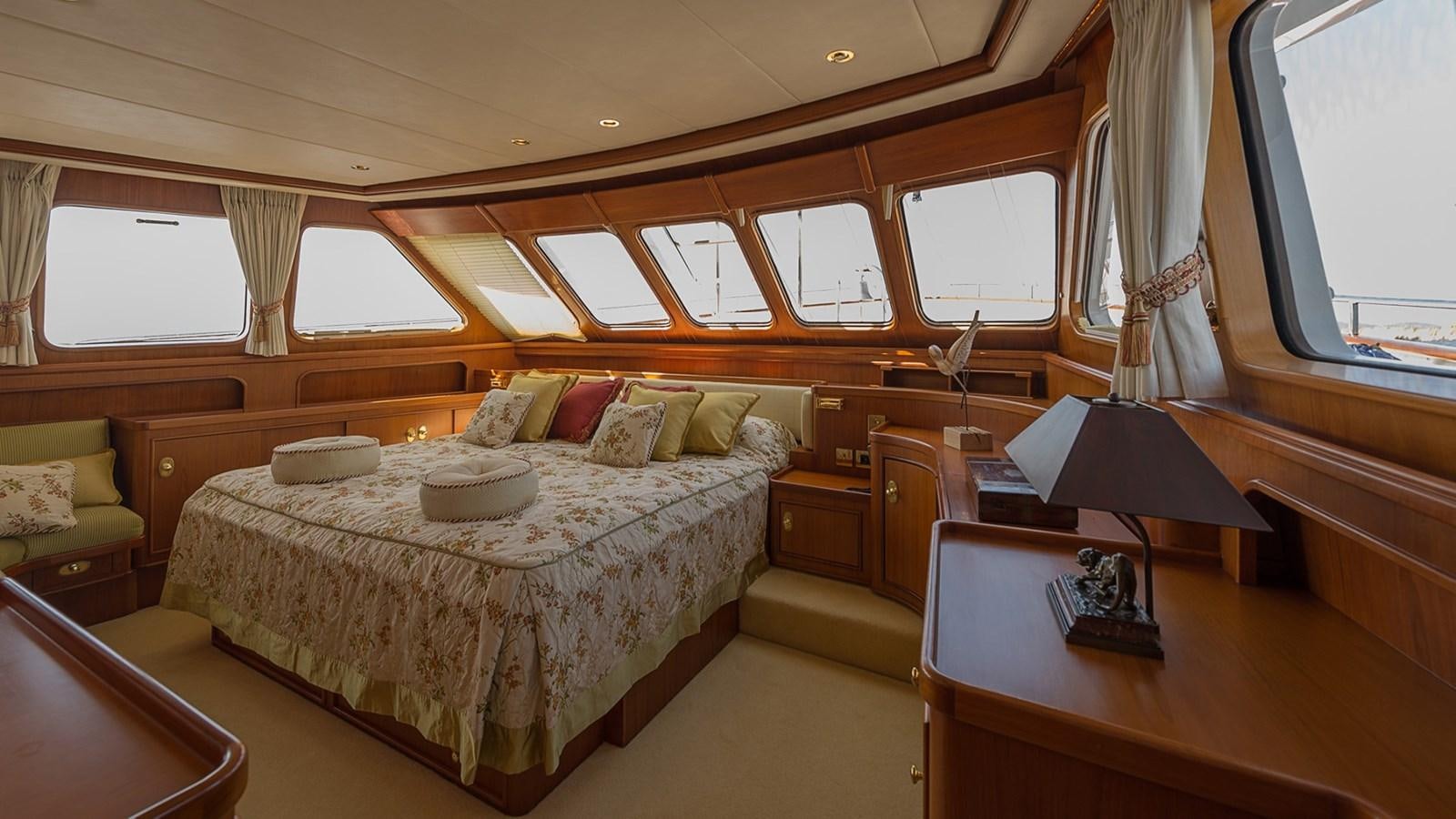 a bedroom with a bed and a desk aboard LA REINA DEL MAR Yacht for Sale