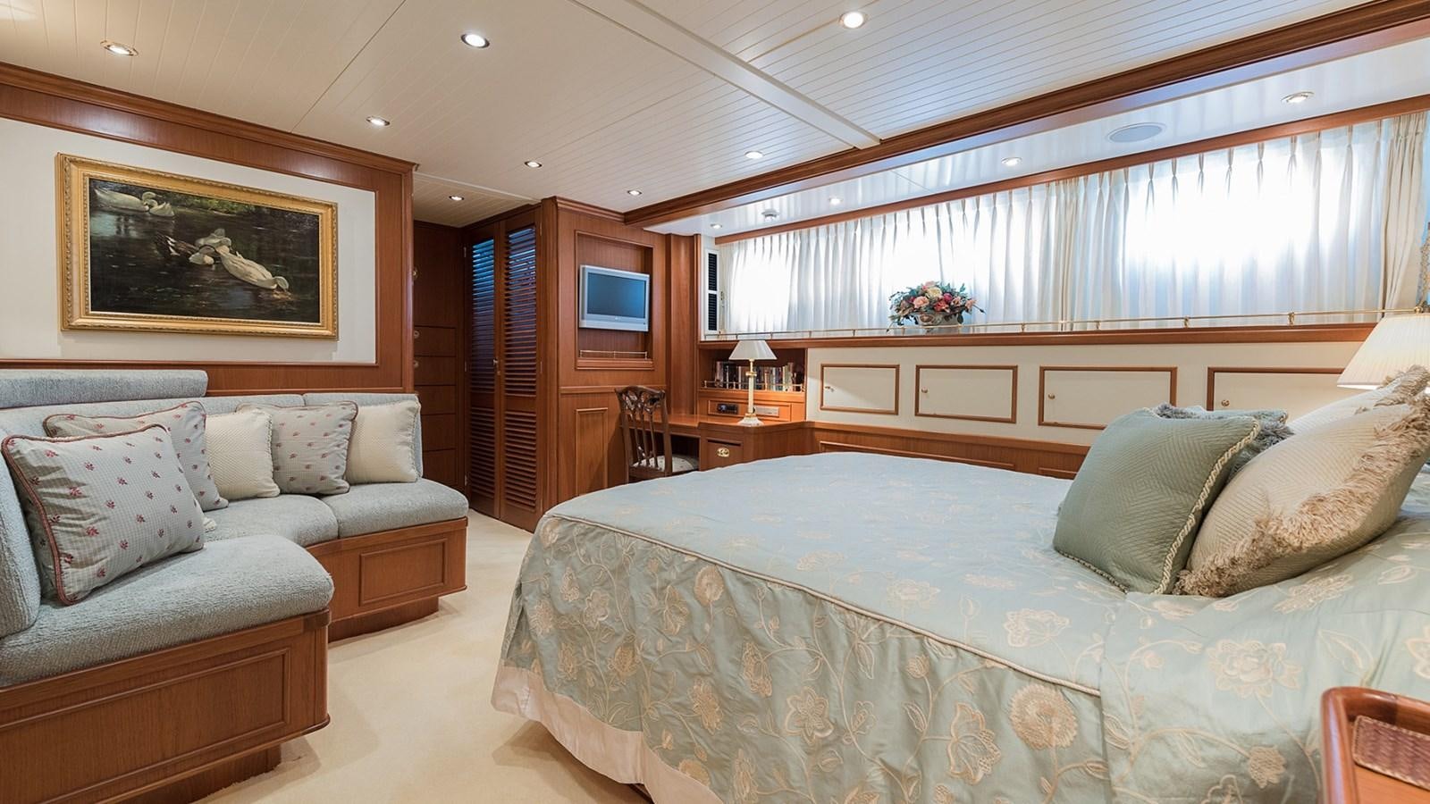 a bedroom with a bed and a couch aboard LA REINA DEL MAR Yacht for Sale