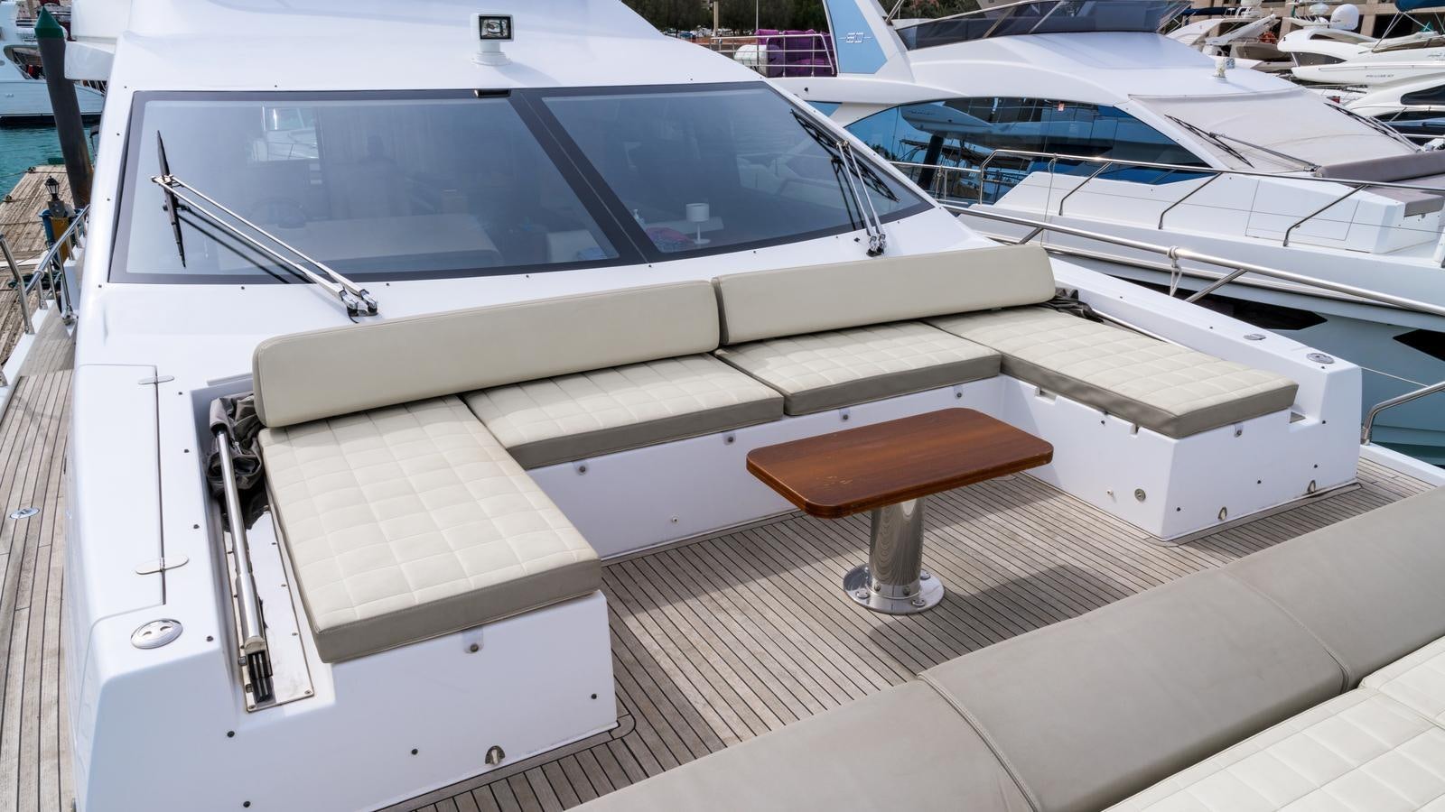 a white yacht with a seat aboard TK Yacht for Sale