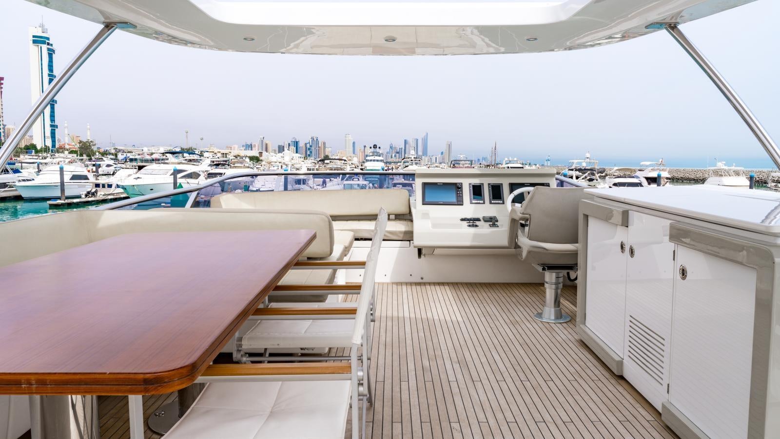 a deck with a view of a city and water aboard TK Yacht for Sale