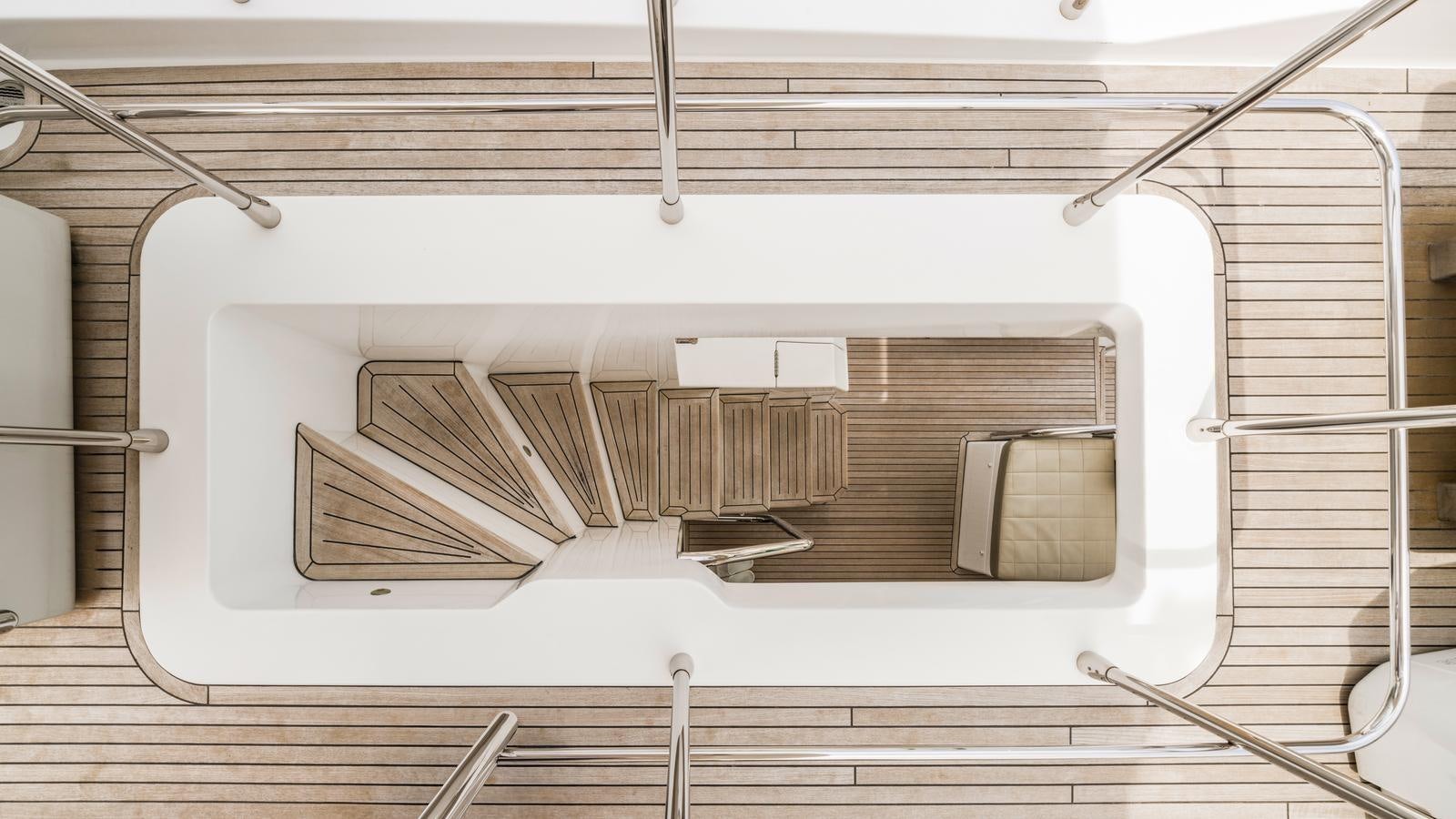 a room with a wood floor and a ladder aboard TK Yacht for Sale