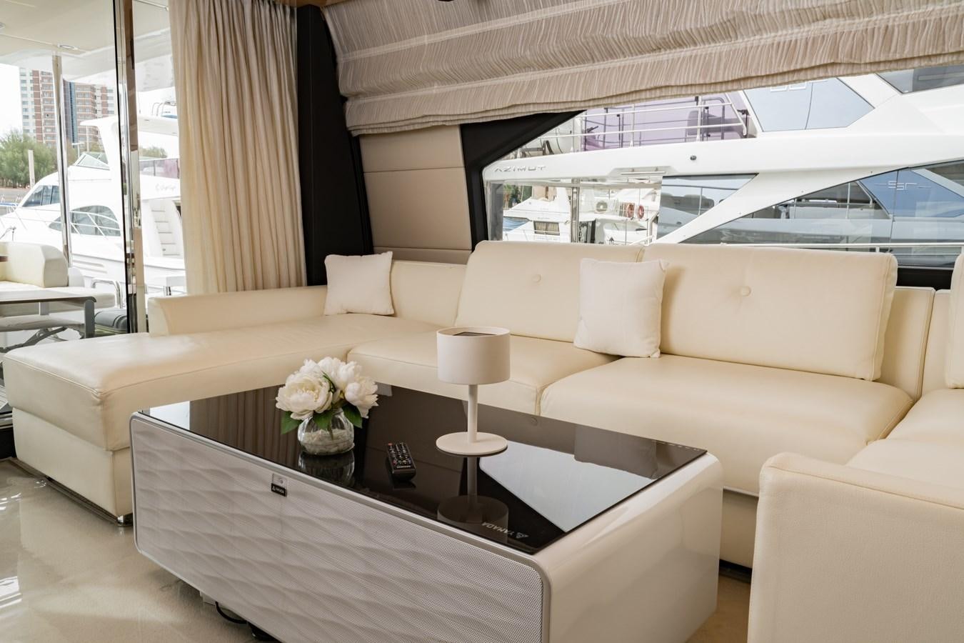 a white couch with a table in front of it aboard TK Yacht for Sale